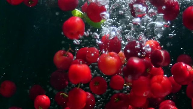 Falling Red Berries Slow Motion. Fruits. Healthy Food. Acerola berry cherry