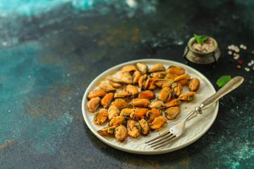 mussels in oil and spices (appetizer mollusks, pickled seafood, healthy food) menu concept. food background. copy space. Top view
