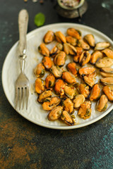 mussels in oil and spices (appetizer mollusks, pickled seafood, healthy food) menu concept. food background. copy space. Top view