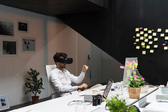 Businessman using VR viewer in office