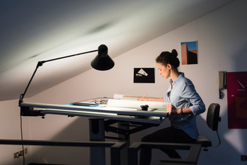 Young woman drawing in her studio