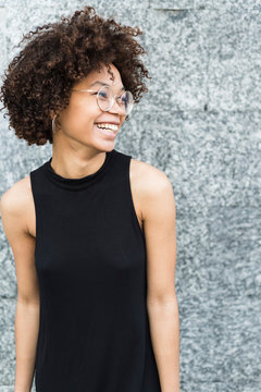 Happy black young woman portrait in the city