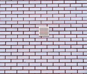 Neat brick wall with centered ventilation architecture background