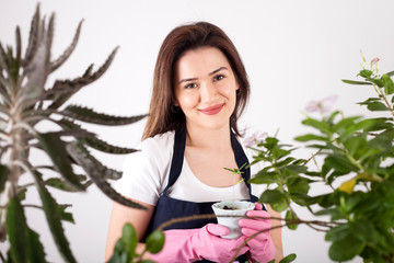 young woman gardening at greenhouse