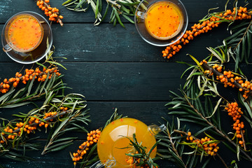 Drink from sea buckthorn berries. Winter hot drink. Fresh sea buckthorn on a twig. Top view. Free...