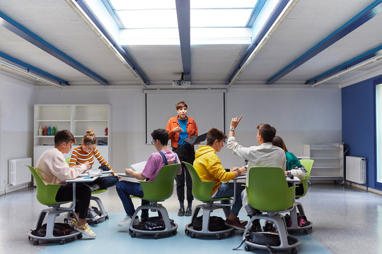 Teenage students and their teacher in the classroom