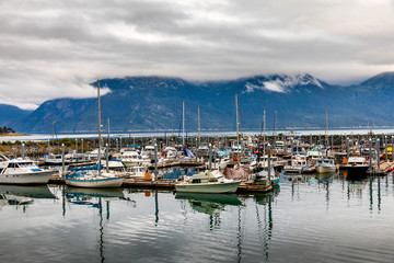 Fototapeta na wymiar Harbor with Boats, Mountains, Clouds
