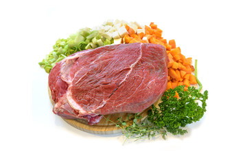 Raw beef meat and vegetable slices, cooking ingredients for a festive Christmas dinner, isolated on a white background, copy space