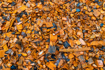 Colored textured sawdust. Small pieces of wood of different sizes.