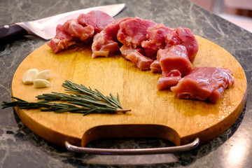 Fresh raw meat lies on a wooden board
