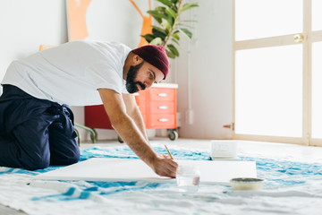 Artist painting in his studio