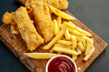 fish and chips with french fries, on a stone background  A