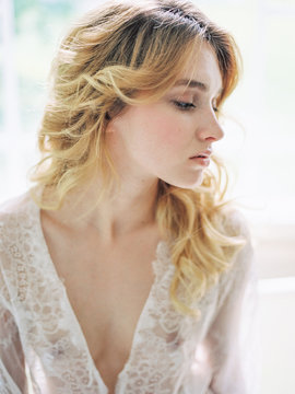Sensual blonde in white lace nightgown