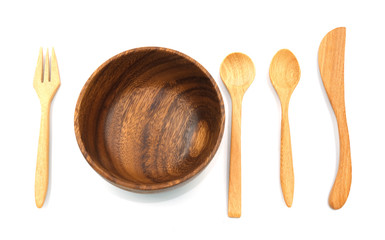 wooden set knife fork and spoon put near bowl for serve. Isolated on white background