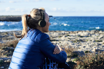 Fitness woman listen music seashore.