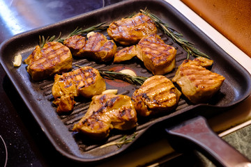 grilled beef steak with rosemary on frying pan