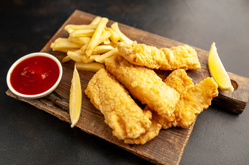 fish and chips with french fries, on a stone background  A