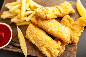 fish and chips with french fries, on a stone background  A