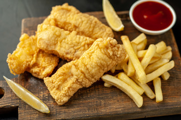 fish and chips with french fries, on a stone background