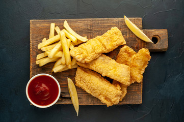fish and chips with french fries, on a stone background