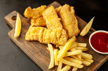 fish and chips with french fries, on a stone background