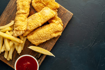 fish and chips with french fries, on a stone background