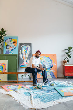 Artist painting in his studio