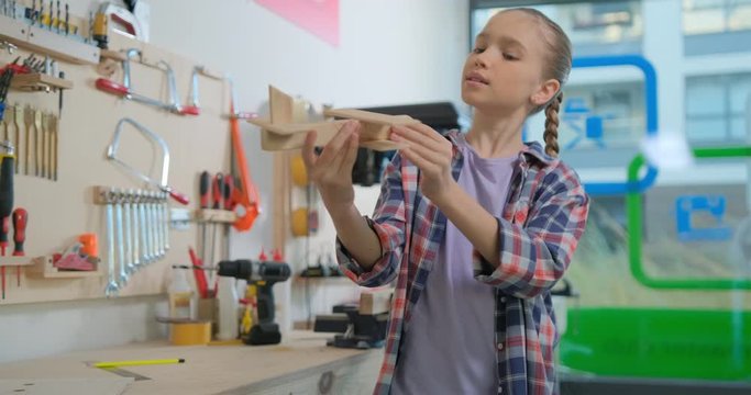 Preteen girl viewing aircraft model in the workshop