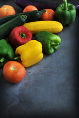 Colorful fresh mixed vegetables over black background with copy space