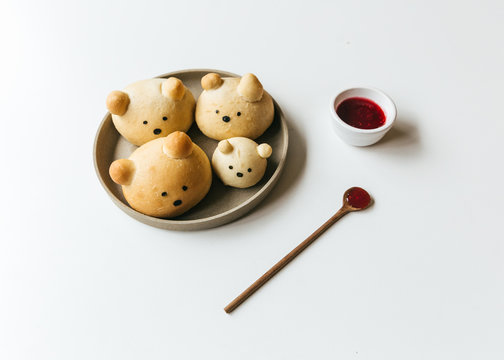 Homemade bear bread buns plated with honey and jam