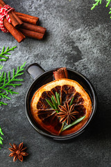 Obraz na płótnie Canvas Christmas mulled wine on a wooden table. Traditional hot drink at Christmas (red wine with spices, New Year's Eve, Noel holiday festive) negroni cocktail. food background. copy space. Top viev