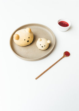Homemade bear bread buns plated with honey and jam