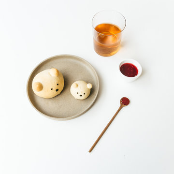 Homemade bear bread buns plated with honey and jam