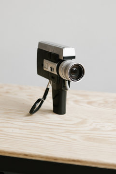 super 8 film camera sitting on plywood table