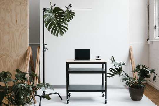 utility cart with laptop plants and props in natural light photo studio