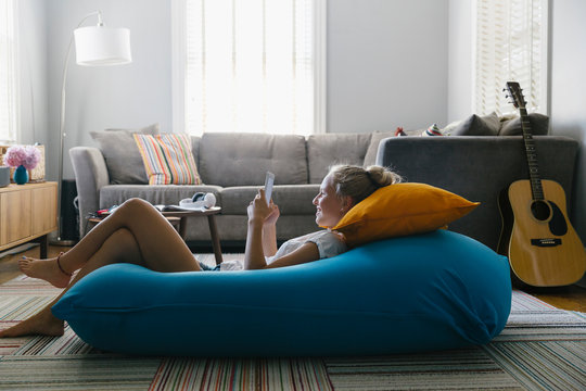 Teenager on Cell Phone with Bean Bag Chair