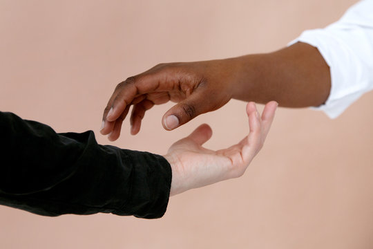 Black and white hands touching each other