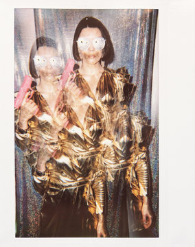 Multiple Exposure Of Glam Girl With Pink Gun