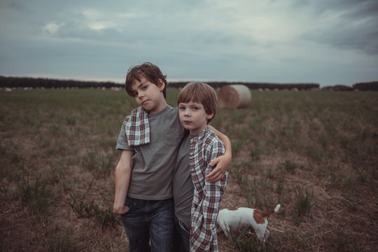 Two little brothers in a field