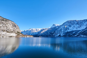 Panoramic mountain landscape of Hallstatt lake at sunny day in Austrian Alps, Salzkammergut region.