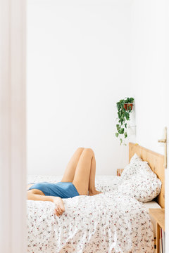 Woman lying on bed.