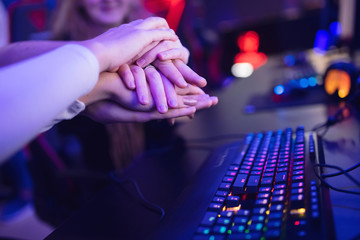 Hand of team man and girl professional gamer playing tournaments online games computer with...