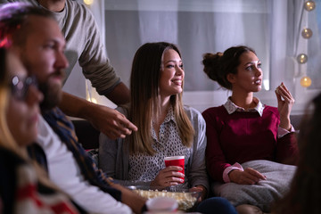 Movies night - group of friends watching a movie together at home
