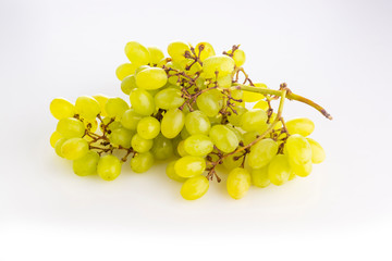 A bunch of green ripe grape raisins on light background
