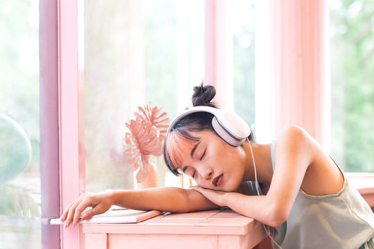 Young Asian Woman Listening To Music