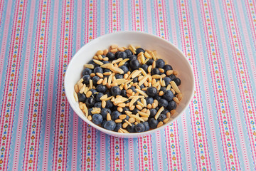 Breakfast: oatmeal with blueberries, pine nut and almonds. Pattern background