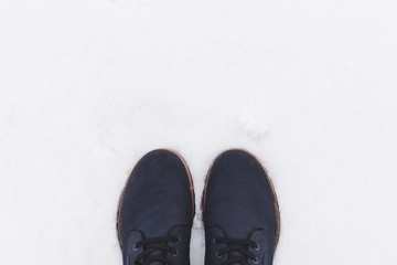 Blue boots on white snow