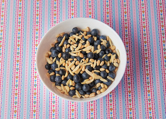 Breakfast: oatmeal with blueberries, pine nut and almonds. Pattern background