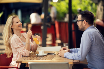 Happy woman enjoying on a date with her boyfriend in a cafe,