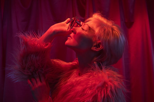 Model in fur jacket and sunglasses looking up
